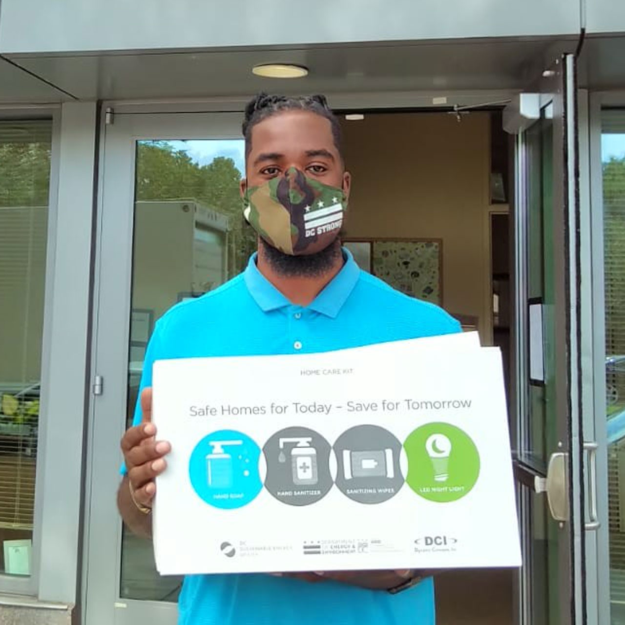 Man wearing a mask and holding a free energy kit