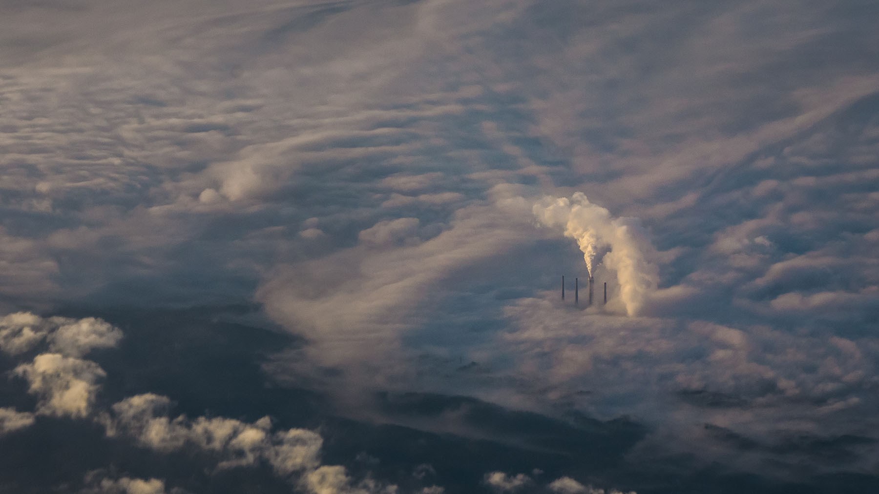 building pokes through low clouds