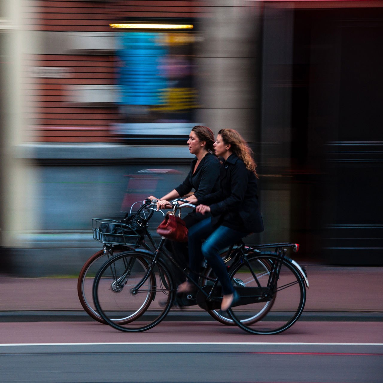 women riding bicycles through a city
