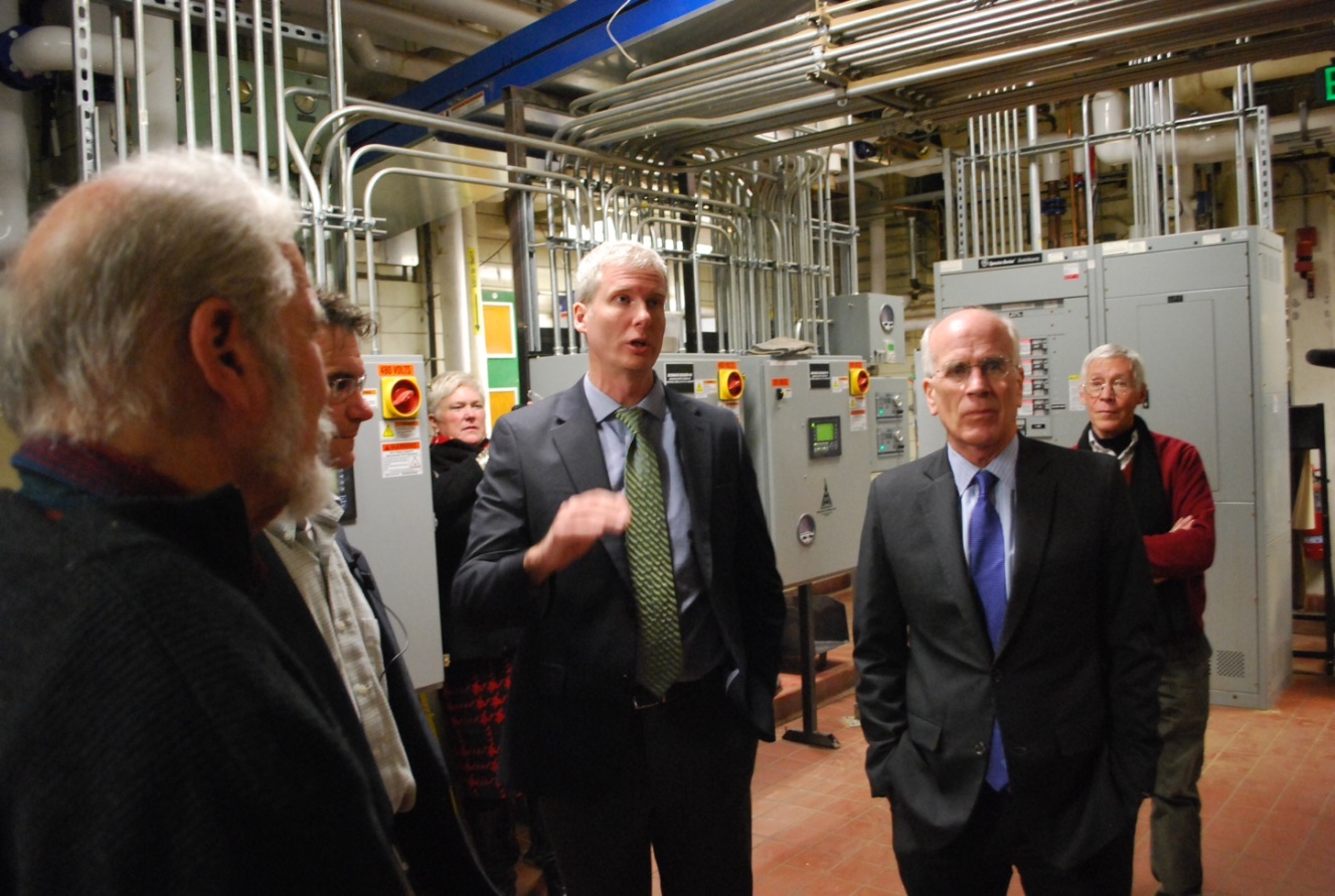 people standing around a biomass plant