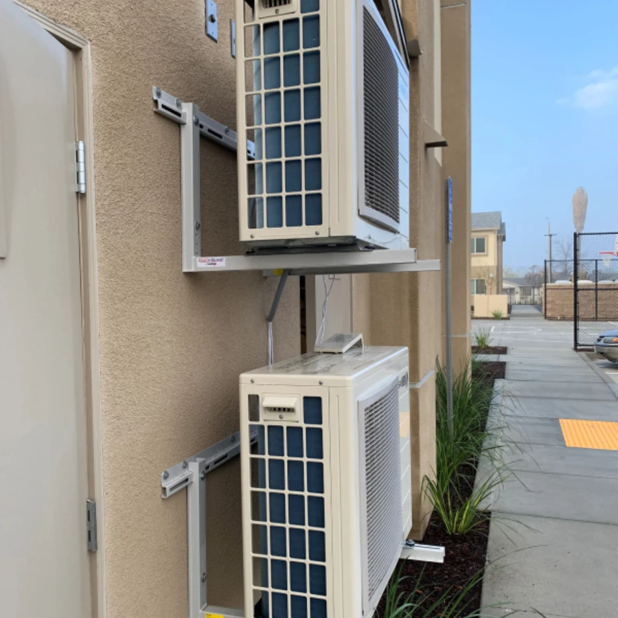 Heat pumps mounted on the exterior of a condo building