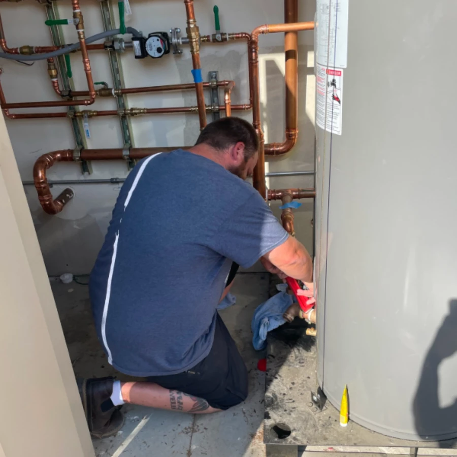 Person installing a hot water heater